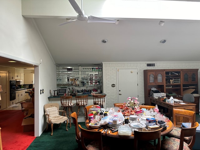 carpeted dining room with ceiling fan and crown molding