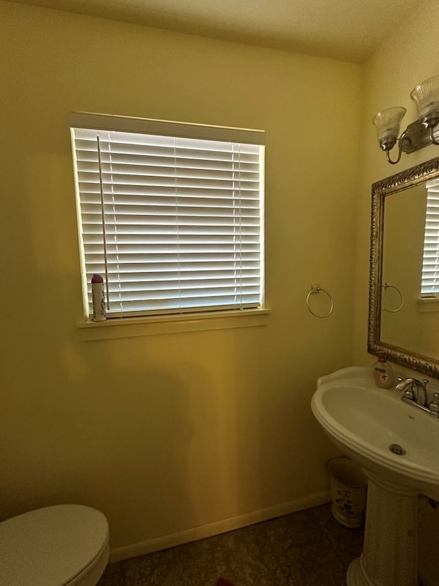 bathroom featuring toilet and a wealth of natural light