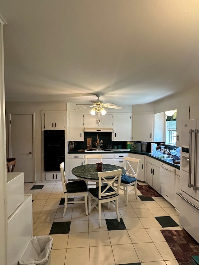 kitchen featuring light tile patterned floors, white appliances, white cabinetry, and ceiling fan