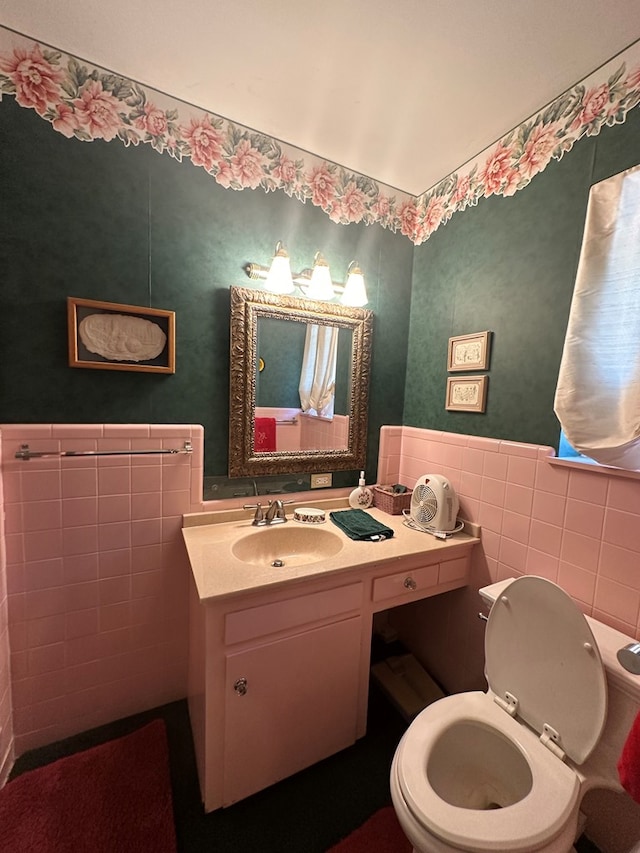 bathroom with vanity, tile walls, and toilet