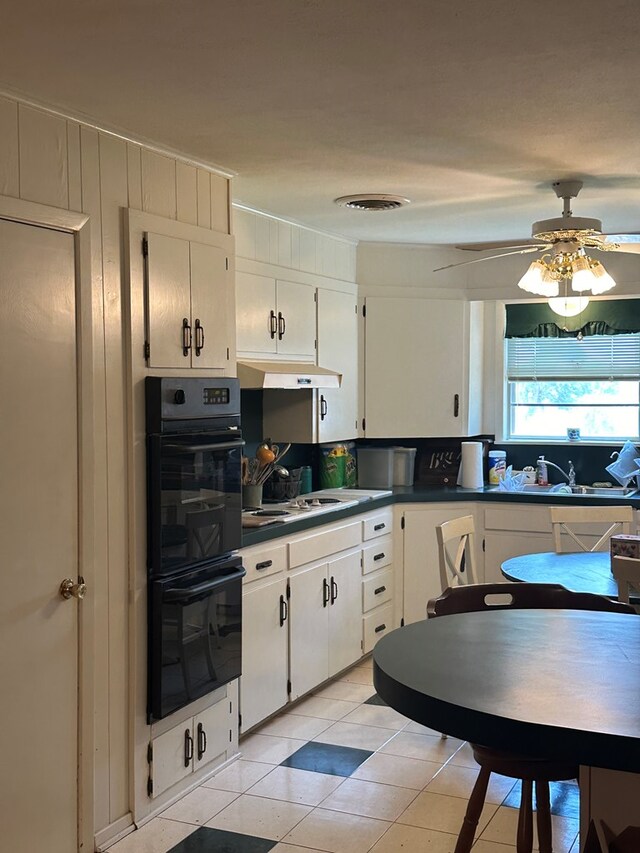 kitchen with white gas cooktop, double oven, ceiling fan, sink, and white cabinetry