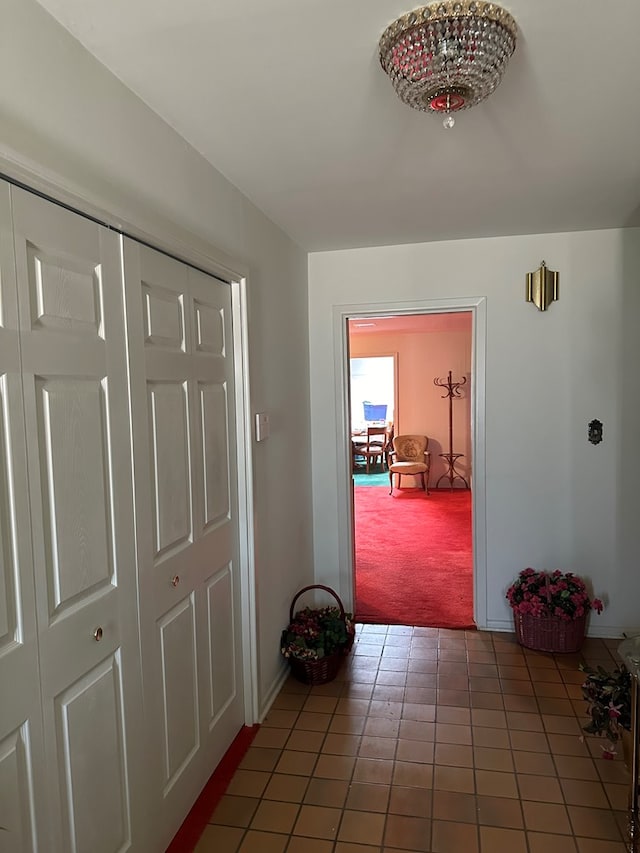 hallway featuring dark colored carpet