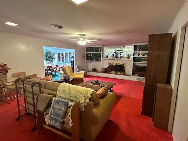 carpeted living room featuring ceiling fan and a brick fireplace