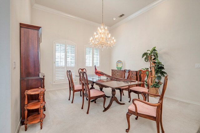 dining room featuring crown molding, baseboards, visible vents, and light carpet