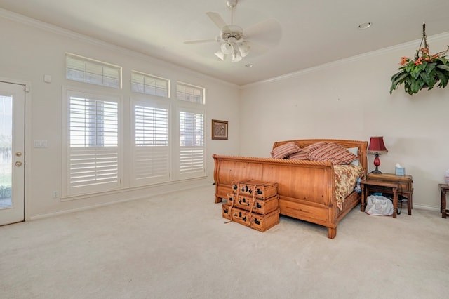 carpeted bedroom featuring baseboards, ornamental molding, and ceiling fan