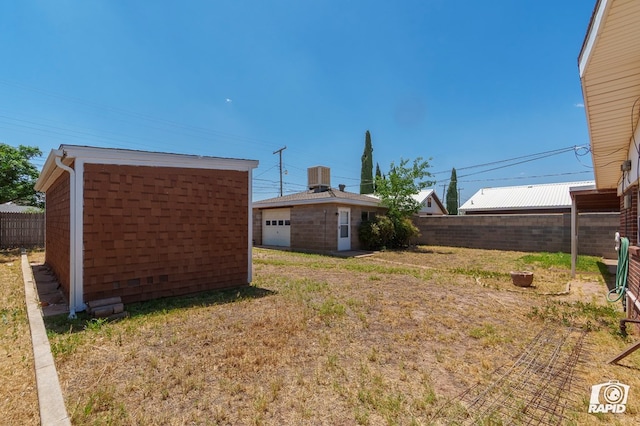 404 E Dormard Ave, Midland, TX 79705 - view of yard with fence, an outbuilding, and central AC
