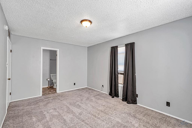 carpeted spare room with a textured ceiling