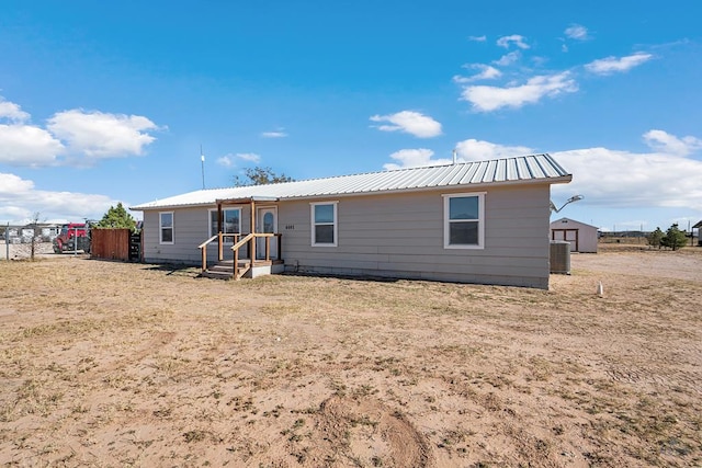 rear view of property featuring central air condition unit