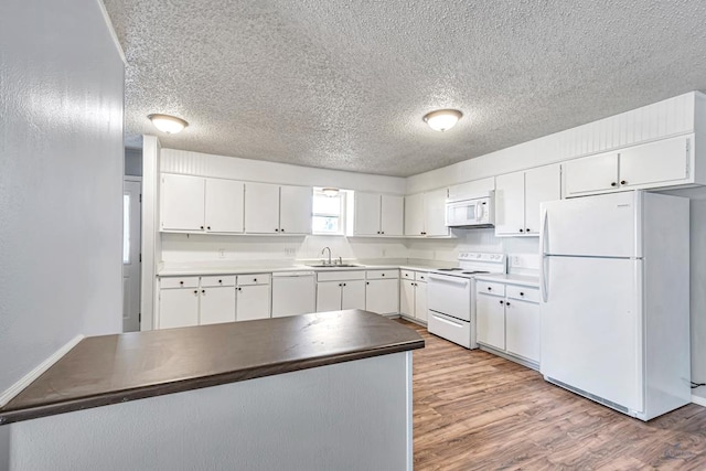 kitchen featuring white cabinets, light hardwood / wood-style floors, white appliances, and sink