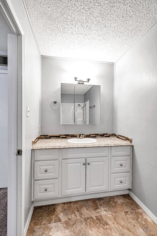 bathroom featuring vanity and a textured ceiling