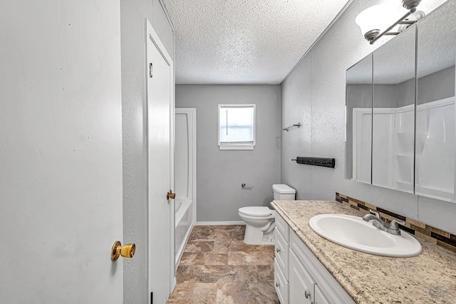 bathroom featuring vanity, a textured ceiling, and toilet