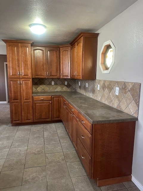 kitchen featuring dark countertops and brown cabinetry