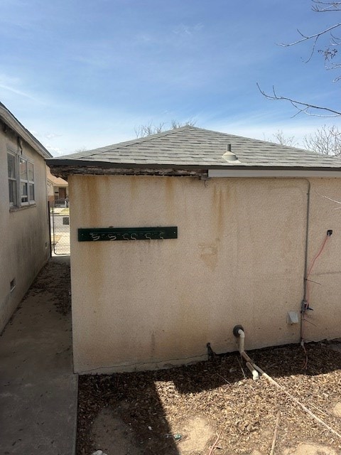 view of side of property with a shingled roof