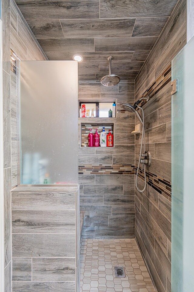 full bathroom with a stall shower and tile patterned floors