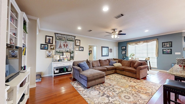living area with crown molding, ceiling fan, light wood finished floors, recessed lighting, and baseboards