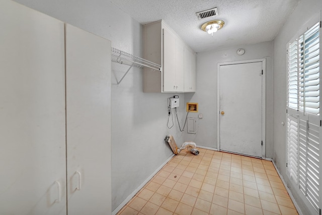 4205 Irvin Dr, Midland, TX 79705 - laundry area with a textured ceiling, hookup for a washing machine, and cabinet space