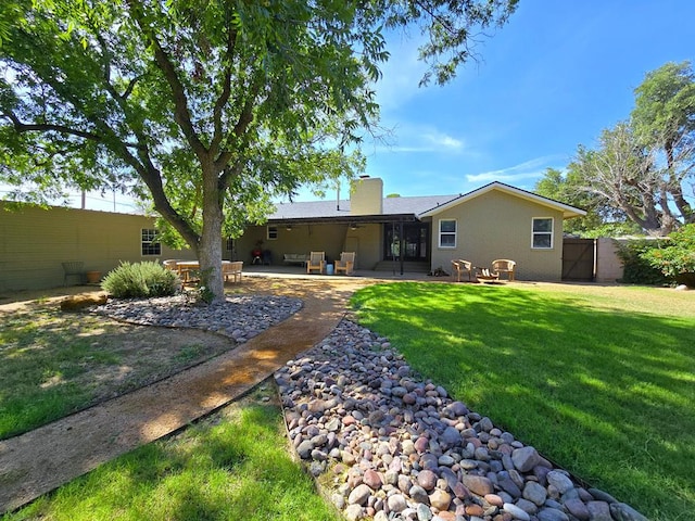 1200 W Cuthbert Ave, Midland, TX 79701 - back of house with a patio area, a gate, and a chimney
