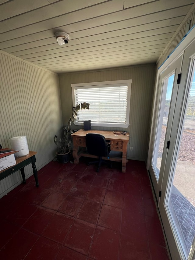 unfurnished office featuring dark tile patterned flooring and wooden ceiling