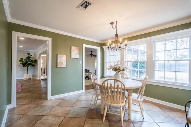 dining area featuring ornamental molding, a chandelier, baseboards, and ceiling fan