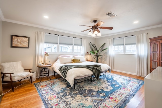 bedroom with crown molding, light wood-style flooring, baseboards, a ceiling fan, and recessed lighting