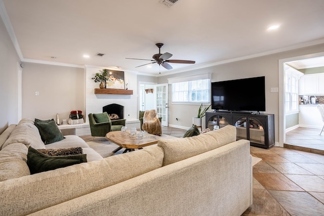 living area featuring baseboards, a fireplace, ceiling fan, crown molding, and recessed lighting