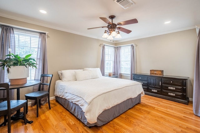 bedroom with multiple windows, light wood finished floors, crown molding, ceiling fan, and recessed lighting
