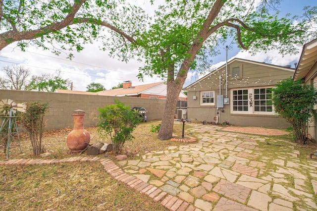 fenced backyard with a patio