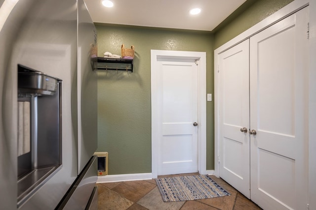 entryway with a textured wall, baseboards, and recessed lighting