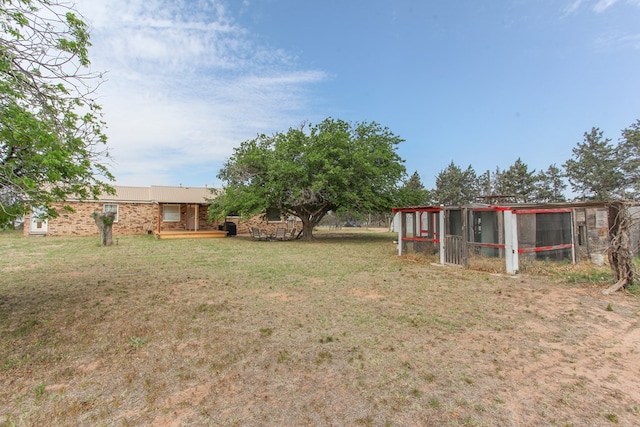 view of yard featuring exterior structure and an outbuilding