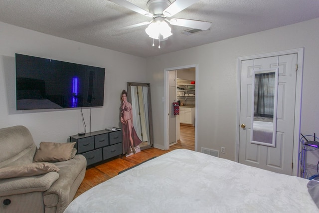 bedroom featuring a ceiling fan, light wood-style flooring, and visible vents