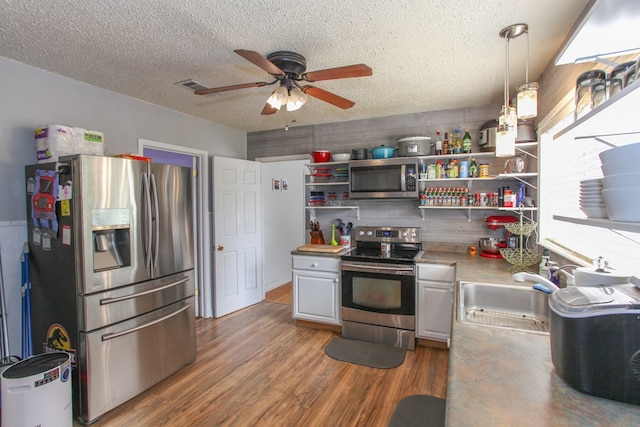 kitchen with ceiling fan, open shelves, a sink, stainless steel appliances, and visible vents