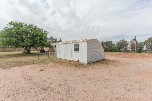 view of shed featuring fence