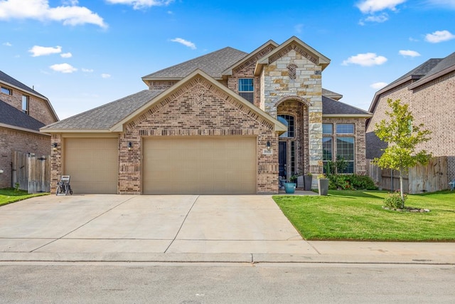 8421 E County Rd 115, Midland, TX 79706 - view of front of home with a garage, brick siding, roof with shingles, and driveway