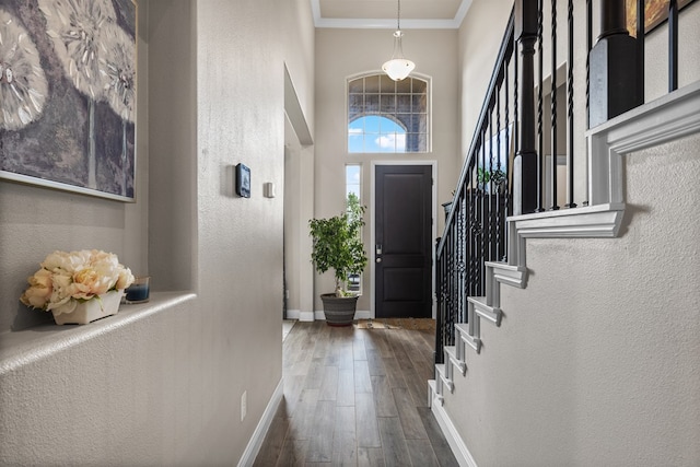 8421 E County Rd 115, Midland, TX 79706 - entryway with baseboards, hardwood / wood-style flooring, ornamental molding, stairs, and a textured wall