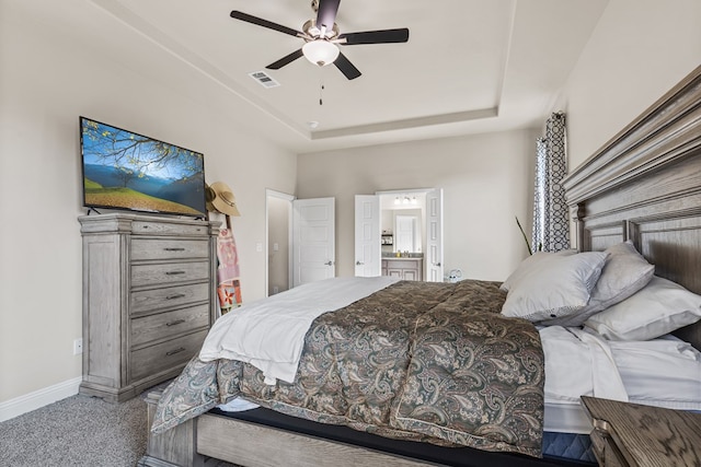 8421 E County Rd 115, Midland, TX 79706 - bedroom featuring carpet floors, a raised ceiling, baseboards, ensuite bathroom, and a ceiling fan