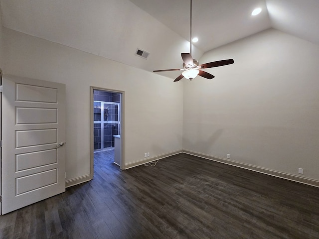 spare room featuring ceiling fan, visible vents, baseboards, vaulted ceiling, and dark wood-style floors