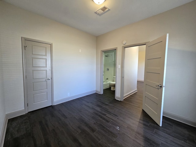 unfurnished bedroom with dark wood-type flooring, visible vents, and baseboards