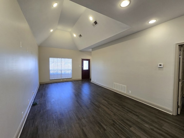 unfurnished living room with lofted ceiling, dark wood finished floors, visible vents, and baseboards