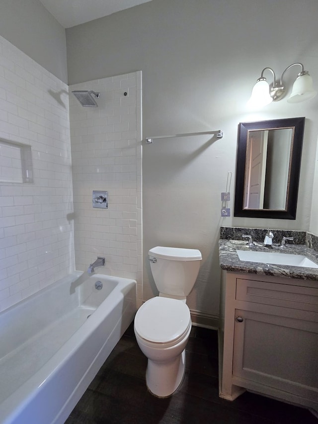 full bathroom with bathing tub / shower combination, toilet, vanity, wood finished floors, and baseboards