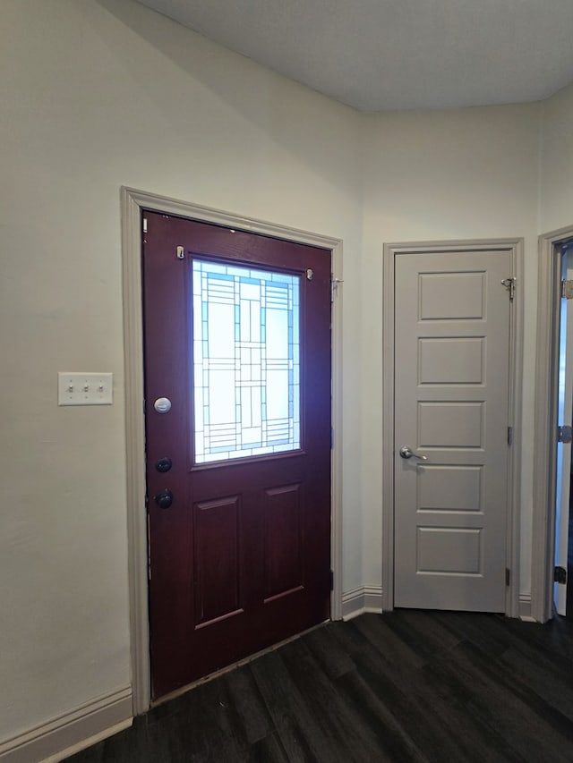 entrance foyer featuring dark wood-style floors and baseboards