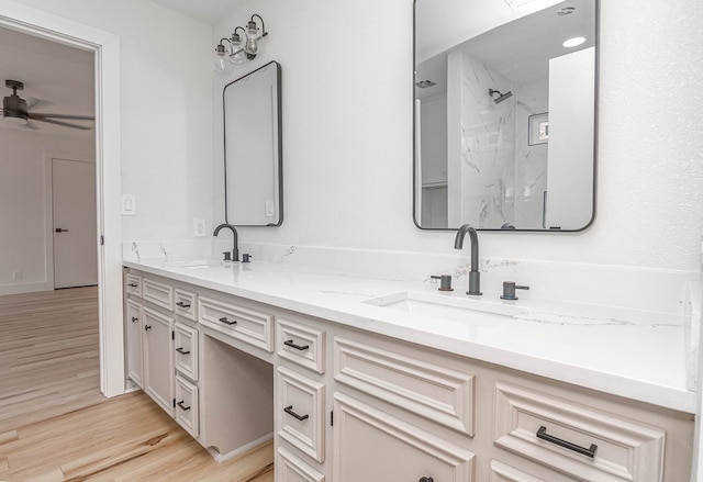 1017 Ward St, Midland, TX 79701 - full bathroom featuring double vanity, wood finished floors, a ceiling fan, and a marble finish shower