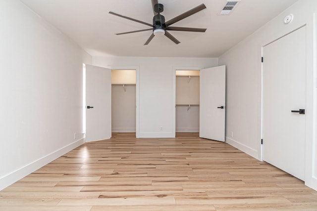1017 Ward St, Midland, TX 79701 - unfurnished bedroom featuring light wood-type flooring, multiple closets, baseboards, and a ceiling fan