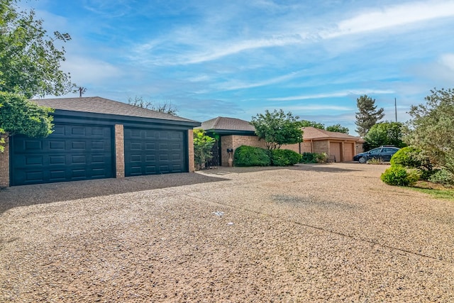 1017 Ward St, Midland, TX 79701 - view of front of house with a garage and gravel driveway