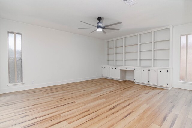 1017 Ward St, Midland, TX 79701 - empty room with a ceiling fan, light wood-type flooring, baseboards, and built in shelves