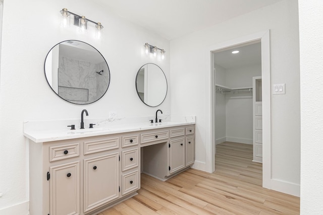 1017 Ward St, Midland, TX 79701 - full bath with double vanity, wood finished floors, baseboards, and a spacious closet
