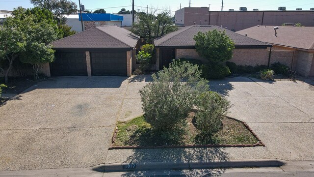 1017 Ward St, Midland, TX 79701 - view of front of home with a detached garage and a shingled roof
