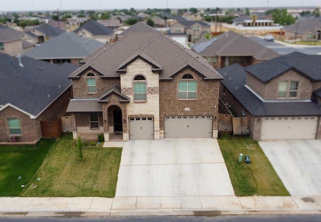 1815 Daybreak Way, Midland, TX 79705 - view of front of property featuring driveway, a residential view, brick siding, and an attached garage