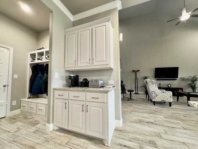 mudroom with baseboards, ceiling fan, and light wood-style flooring