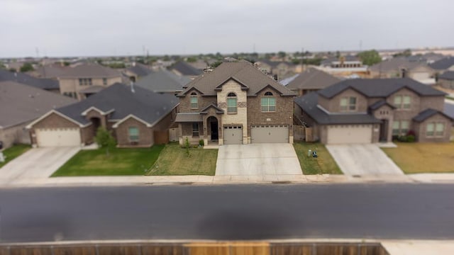 1815 Daybreak Way, Midland, TX 79705 - view of front facade featuring driveway, brick siding, a residential view, and stone siding