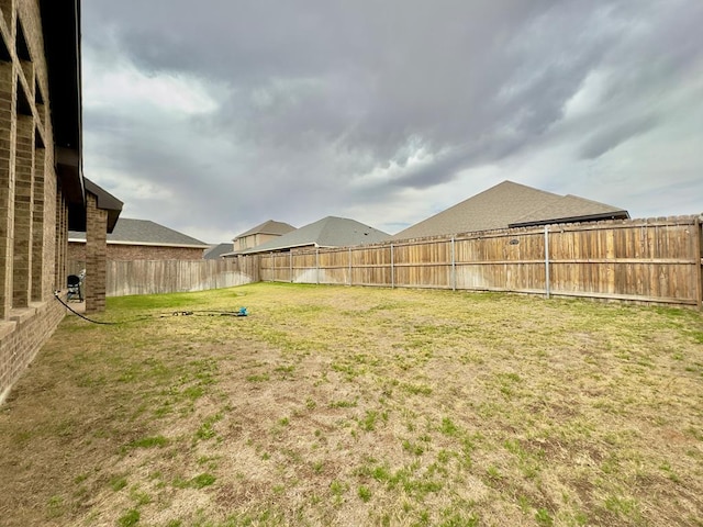 view of yard with a fenced backyard